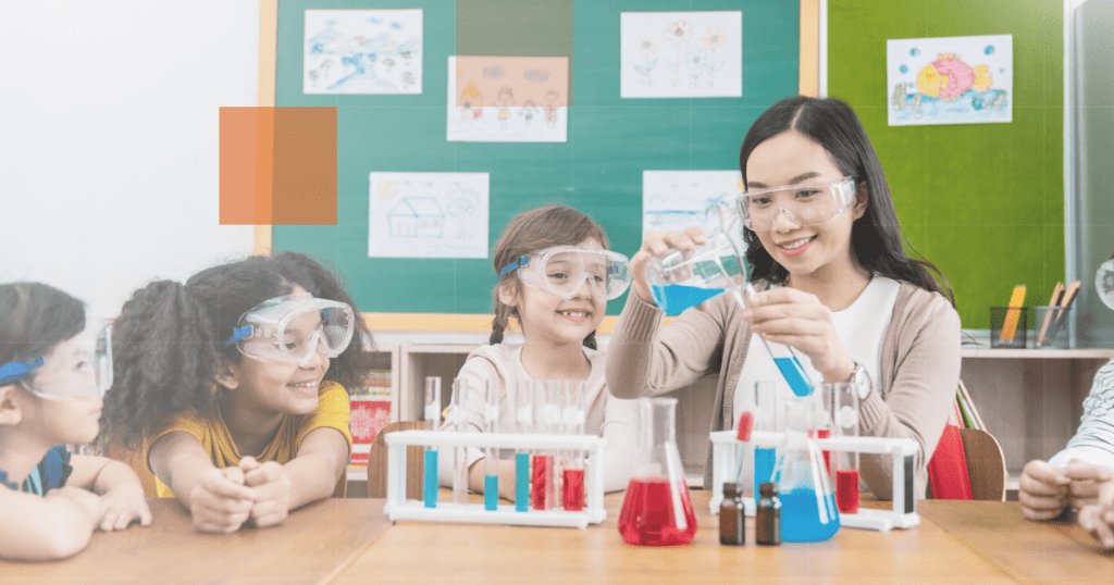 a female teacher holding measuring tools to her students