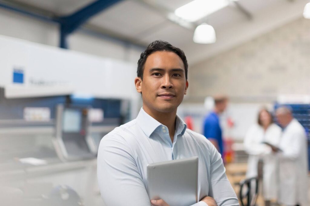 A Filipino engineer in a research lab holding a tablet