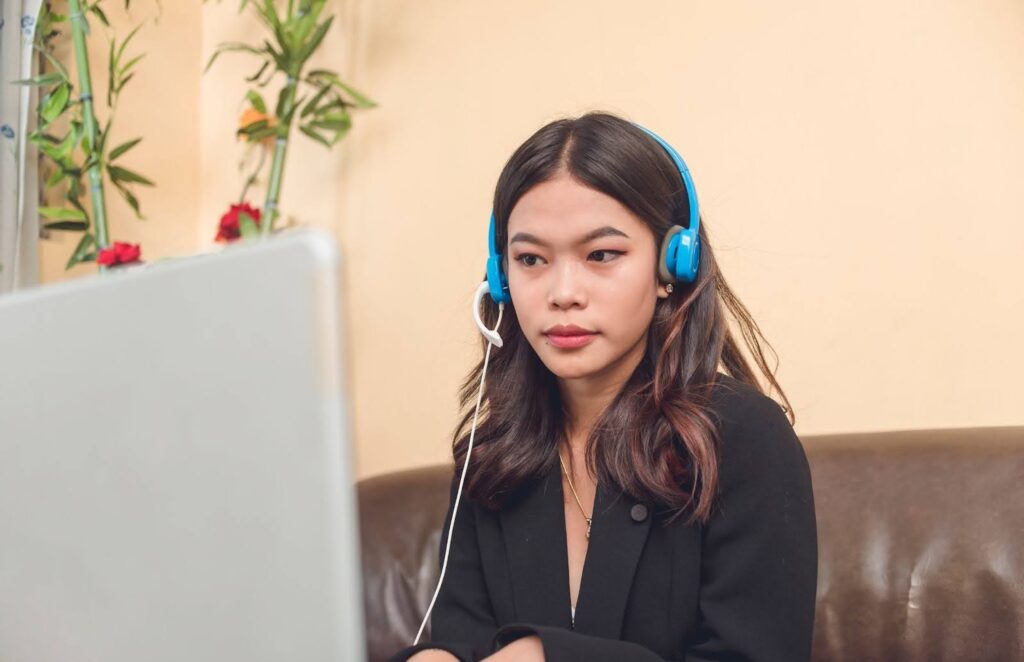 An outsourced Filipino customer service representative working remotely from her living room