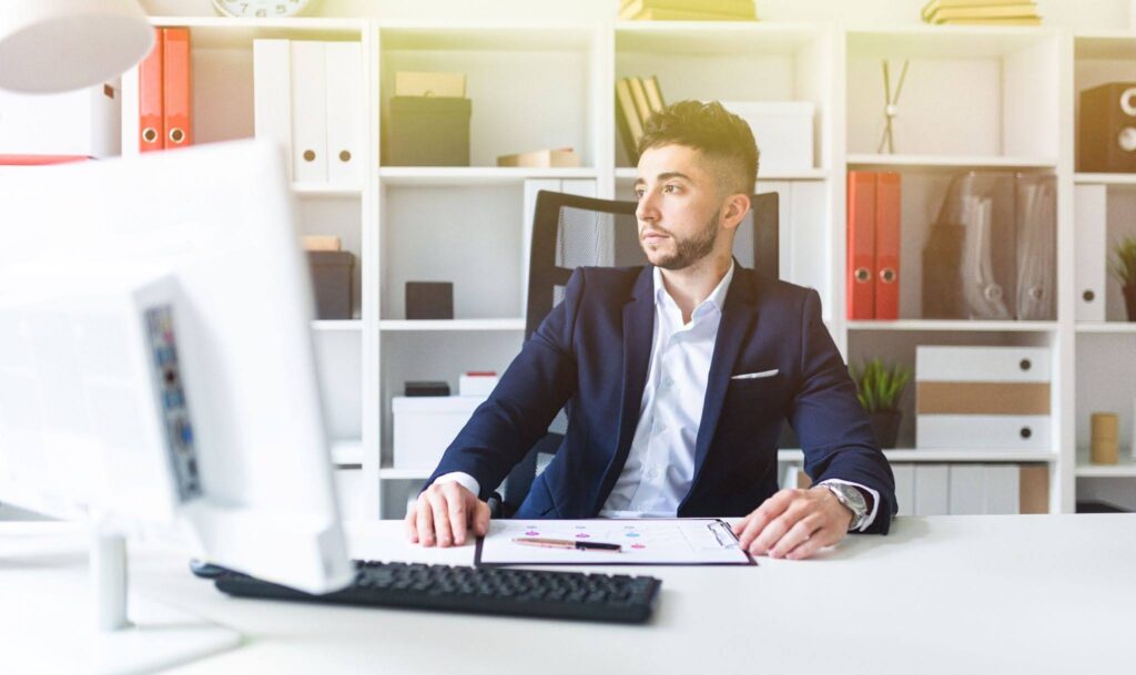 An Armenian male professional working in his office