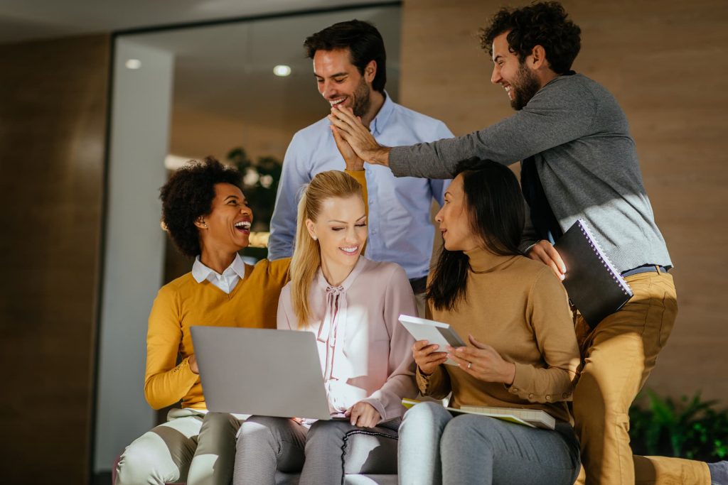 A team enthusiastically high-fiving during a brainstorming session