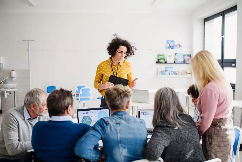 A corporate trainer leading an employee training session in a bright office