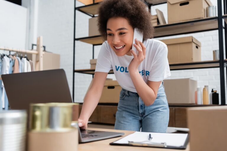 happy african american volunteer talking on smartphone — Top BPO Solutions | Outsourcing Services In The Philippines