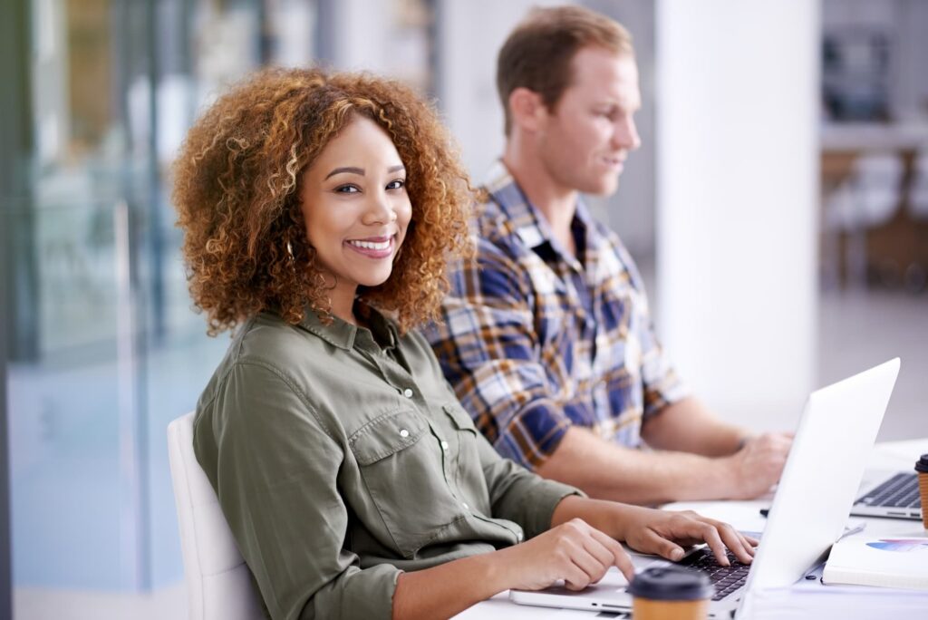 Curly haired lady smiling — Top BPO Solutions | Outsourcing Services In The Philippines