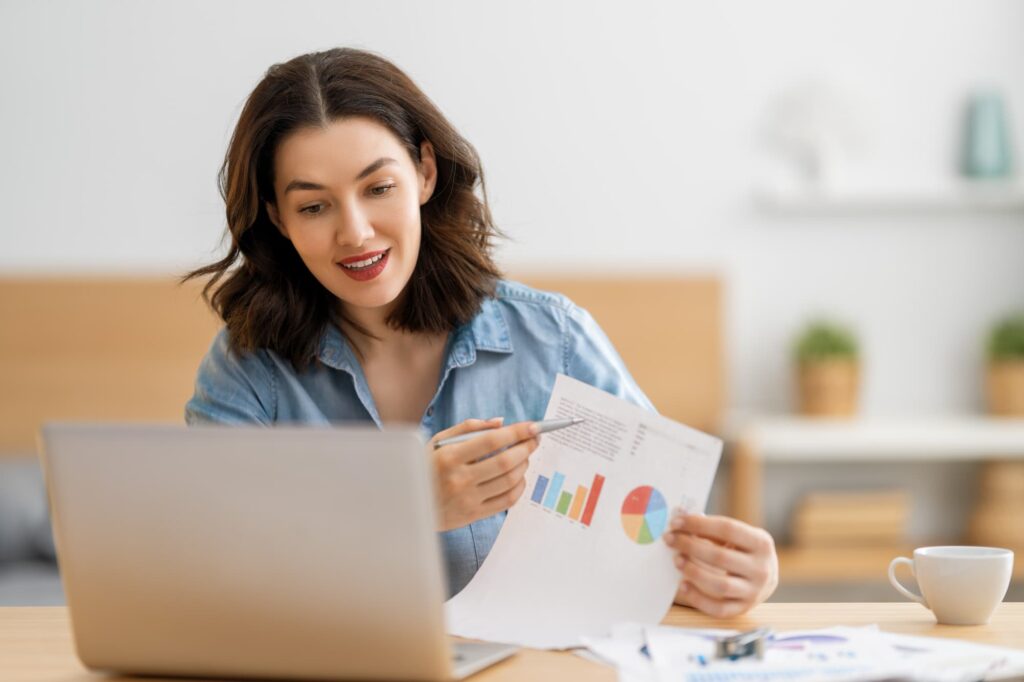 Lady holding a paper with graphs — Top BPO Solutions | Outsourcing Services In The Philippines