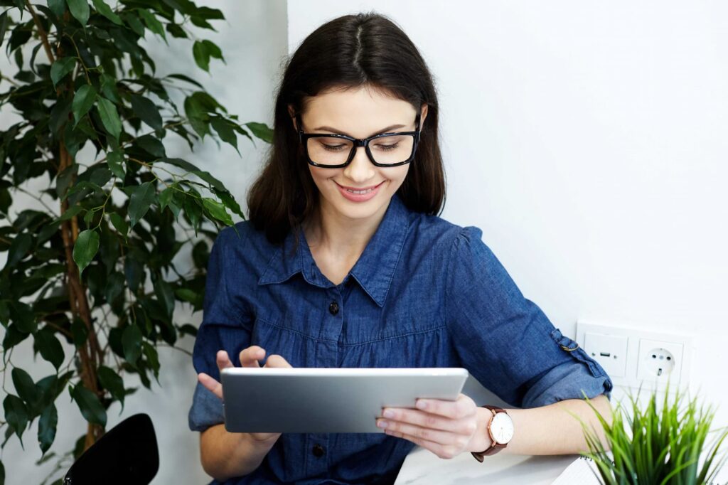 Women wearing blue holding a table — Top BPO Solutions | Outsourcing Services In The Philippines