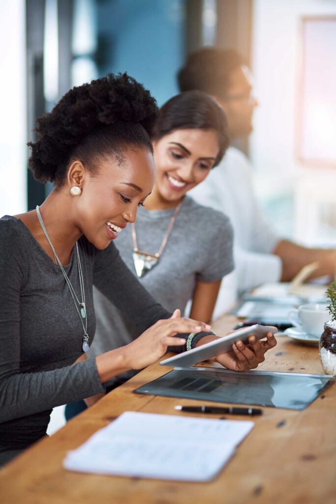 Smiling web developers while working — Top BPO Solutions | Outsourcing Services In The Philippines