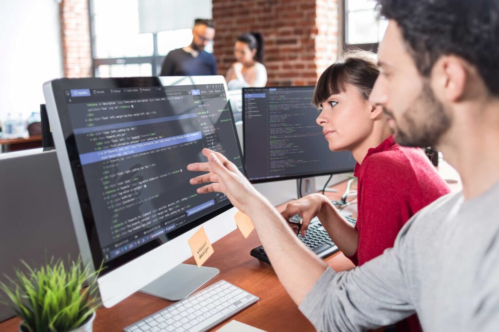 Developer points to his monitor — Top BPO Solutions | Outsourcing Services In The Philippines