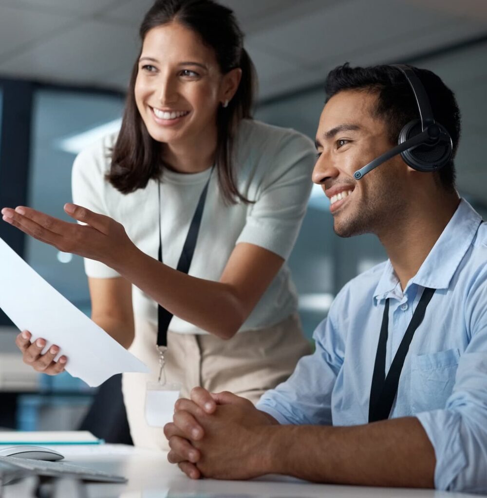 Young man and woman reading a document — Top BPO Solutions | Outsourcing Services In The Philippines