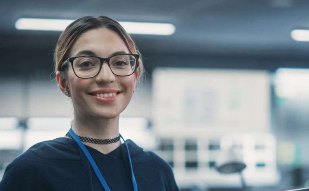 Lady wearing glasses smiling — Business process outsourcing & offshore staffing | Sourcefit