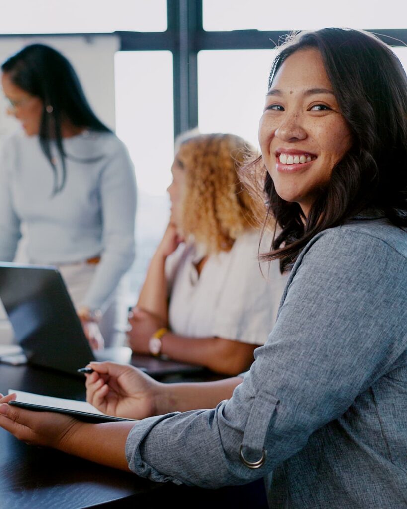 Lady smiling while working — Business process outsourcing & offshore staffing | Sourcefit