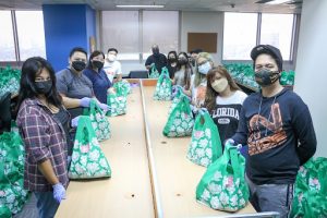 employees wearing mask packing food donation covid