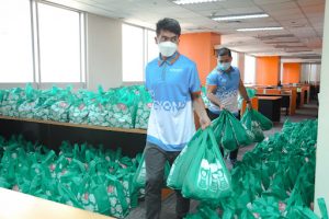 people carrying green donation bags