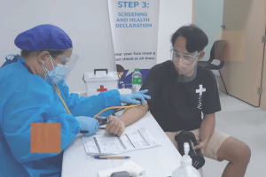 nurse taking man's blood pressure