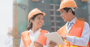 two people wearing safety helmet working as engineer