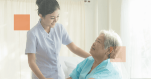 nurse smiling to an old woman patient